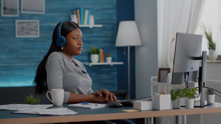 A woman working in a cozy office on her laptop