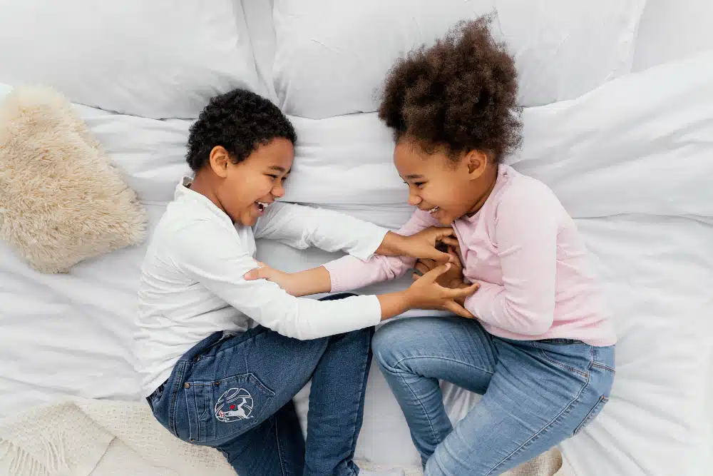 Children playing on the bed- managing sibling rivalry