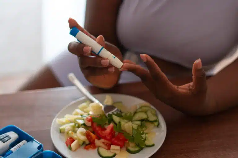 a person holding a device to test the blood sugar for the blog- what is diabetes