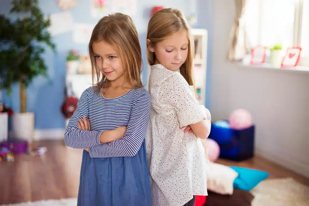 Sulking girls standing back to back
- How To Help Your Kids Make Friends
