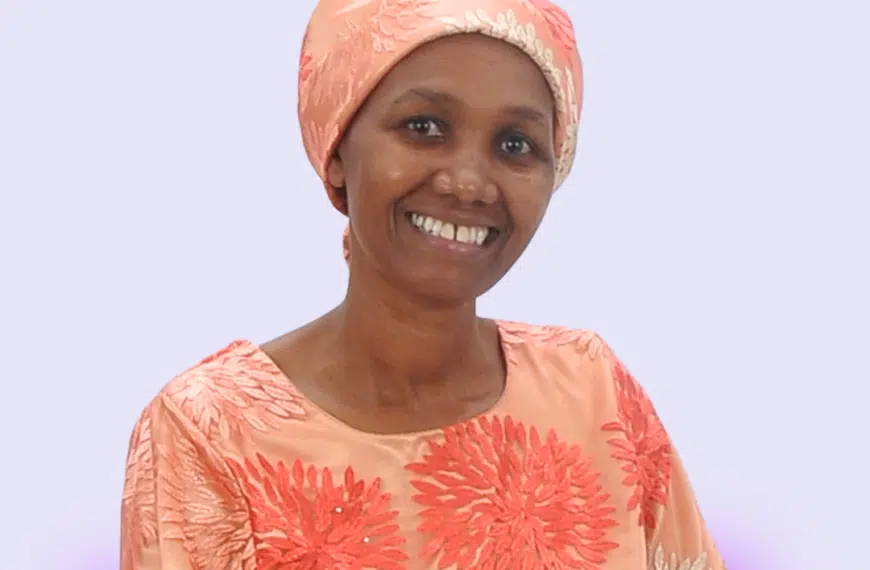 Pastor Teresia Karanja smiling at the camera-