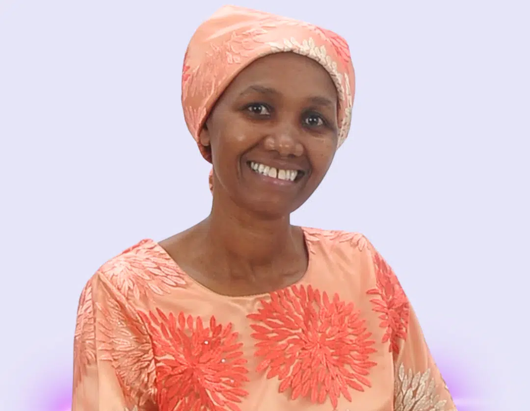 Pastor Teresia Karanja smiling at the camera-